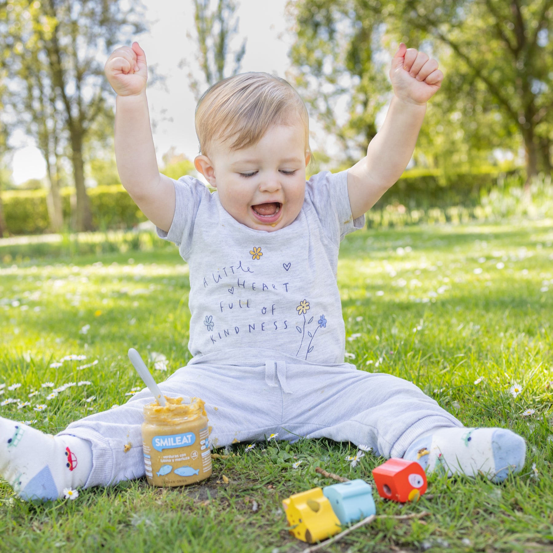Bebé no parque com tarrito biológico – refeição infantil com ingredientes simples e reais